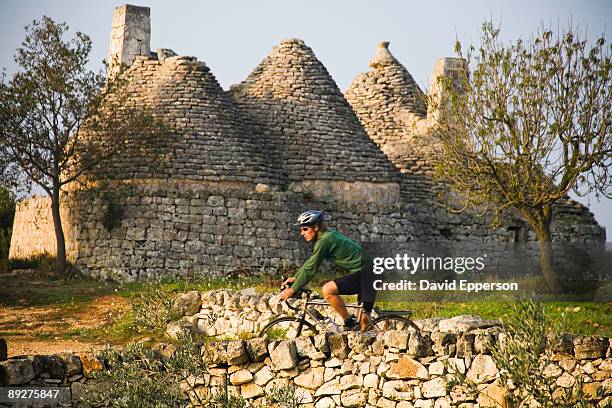 man road cycling in puglia, italy - cisternino fotografías e imágenes de stock