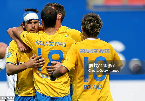 Dennis Kruppke of Braunschweig celebrates with Marco Calamita, Fait-Florian Banser and Mirko Boland after scoring during the 3. Liga match between...