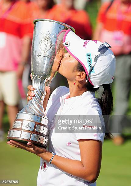 Ai Miyazato of Japan with the winners trophy after winning in a playoff against Sofie Gustafson of Sweden during the final round of the Evian Masters...