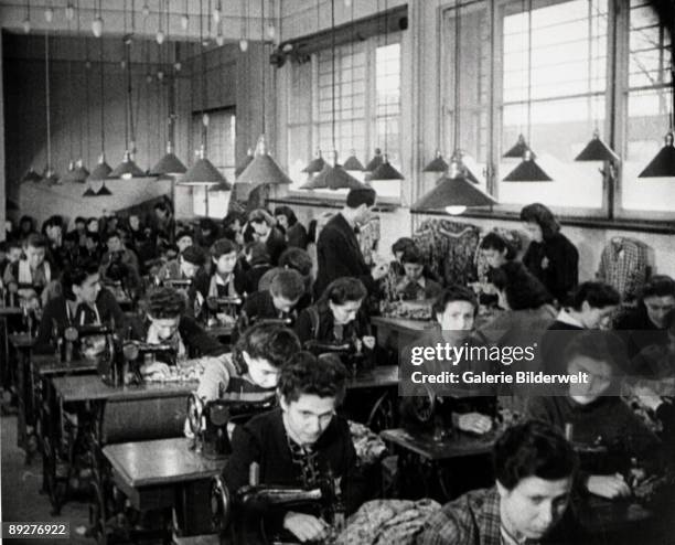 Jewish women are forced to work in a factory in the ghetto in Dabrowa Gornicza, Poland, 1941