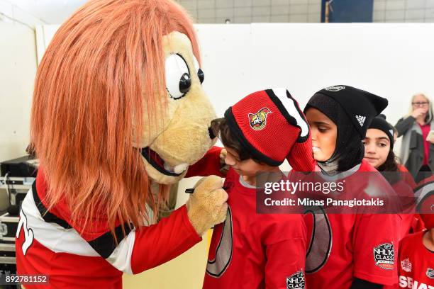 The Ottawa Senators mascot Spartacat signs autographs for the children during the 2017 Scotiabank NHL100 Classic Legacy Project press conference at...