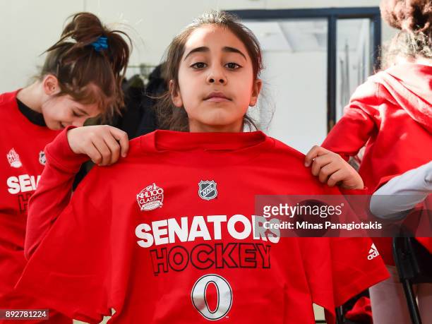 Youngster shows off her new Ottawa Senators shirt during the 2017 Scotiabank NHL100 Classic Legacy Project press conference at the Boys & Girls Club...