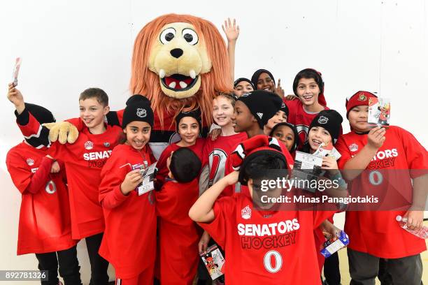 Group of young children pose with the Ottawa Senators mascot Spartacat during the 2017 Scotiabank NHL100 Classic Legacy Project press conference at...