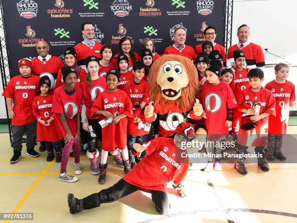 Dignitaries and children pose for a photo during the 2017 Scotiabank NHL100 Classic Legacy Project press conference at the Boys & Girls Club - Police...