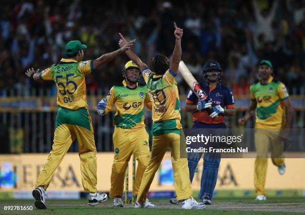 Shahid Afridi of Pakhtoons celebrate with team mates after taking a hat-trick during the T10 League match between Maratha Arabians and Pakhtoons at...