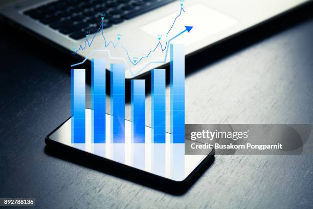 close up of business with smartphone and graphs and charts on screen - 明細 ストックフォトと画像