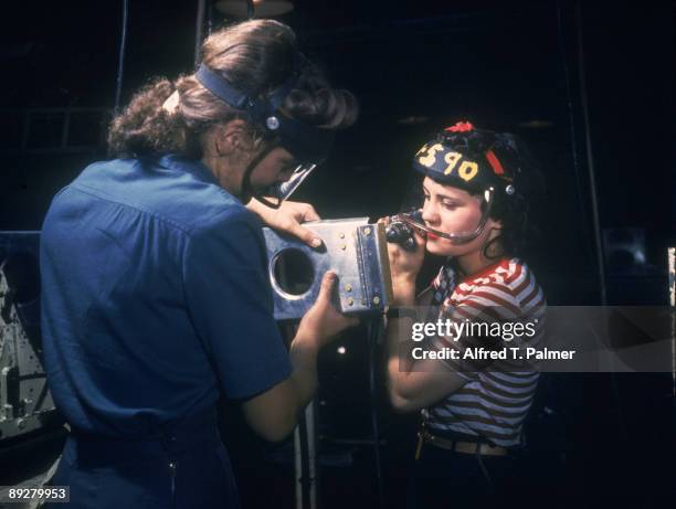 Two North American Aviation, Inc. Employees assemble a section of a wing for a P-51 fighter plane, October 1942.