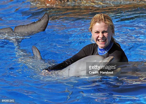 In this handout from SeaWorld San Diego, "True Blood" actor Anna Paquin swims with a bottlenose dolphin during a Dolphin Interaction Program at...
