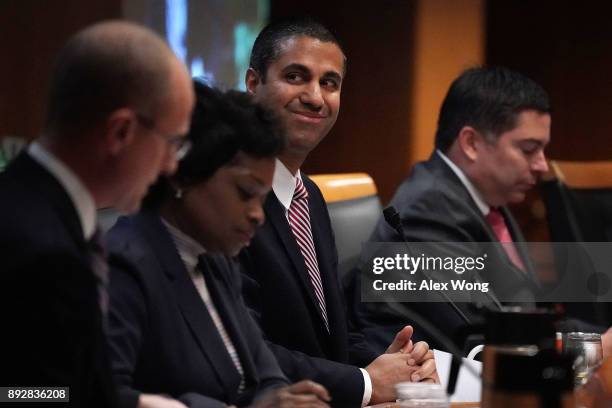 Federal Communications Commission Chairman Ajit Pai smiles during a commission meeting December 14, 2017 in Washington, DC. FCC has voted to repeal...