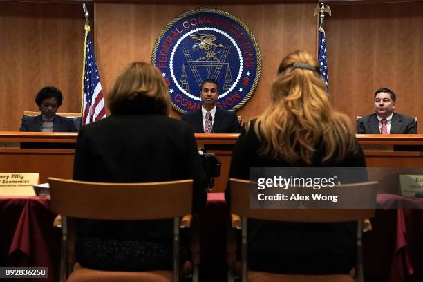 Federal Communications Commission Chairman Ajit Pai and commission members Mignon Clyburn and Michael O'Rielly listen during a commission meeting...