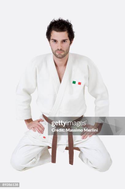 man in karate outfit and brown belt - karate brown belt stock pictures, royalty-free photos & images