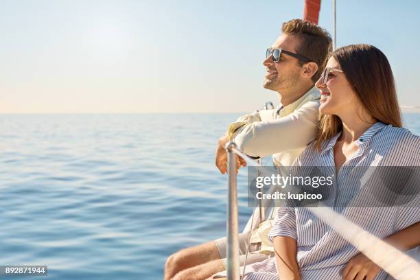 sailing their way through summer - young couple sailing stock pictures, royalty-free photos & images