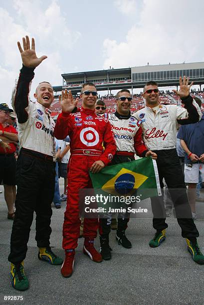 Brazilian drivers,Cristiano da Matta, Bruno Junqueira, Tony Kanaan and Christian Fittipaldi display their support for their soccer World Cup winning...