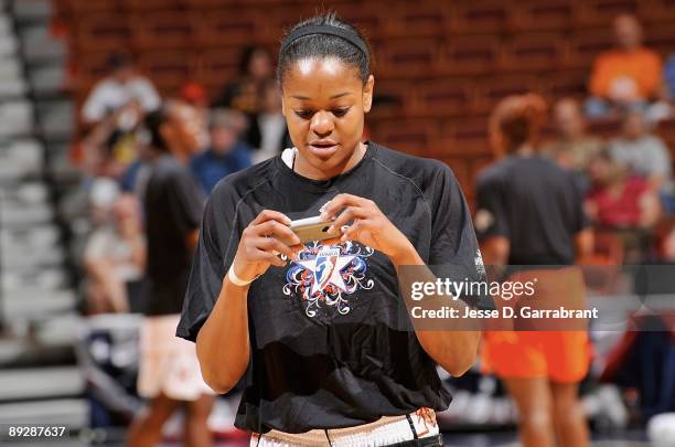 Alana Beard of the Eastern Conference sends a Twitter message during warm ups before the 2009 WNBA All-Star Game at Mohegan Sun Arena on July 25,...