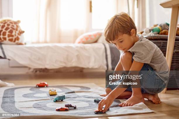 his cars is his favorite thing to play with - domestic room imagens e fotografias de stock