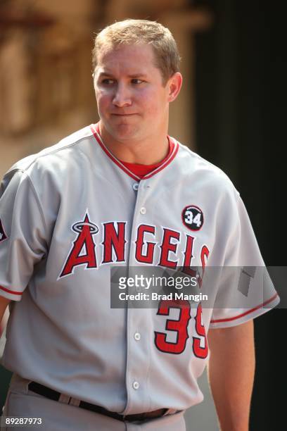 Robb Quinlan of the Los Angeles Angels of Anaheim stands in the dugout against the Oakland Athletics during the game at the Oakland-Alameda County...