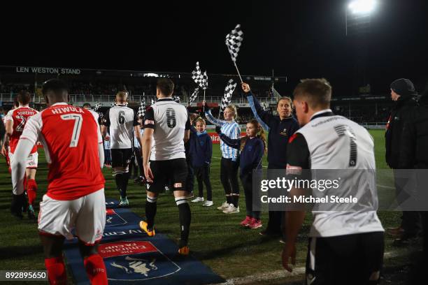 The players enter the pitch during the Emirates FA Cup second round replay match between Hereford FC and Fleetwood Town at Edgar Street on December...