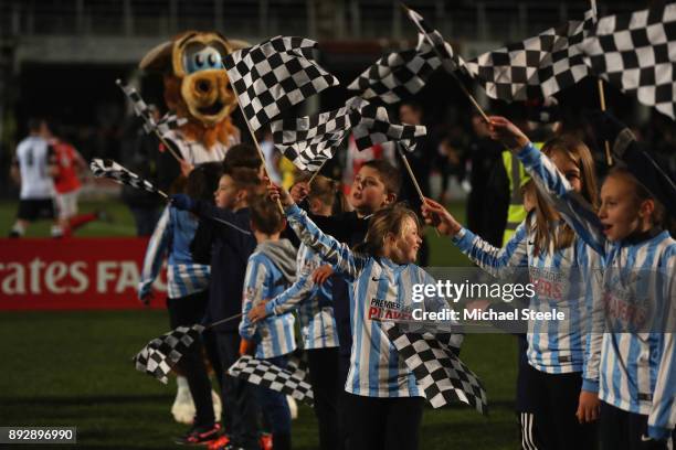Yung Hereford mascots wave flags as the players enter the pitch during the Emirates FA Cup second round replay match between Hereford FC and...