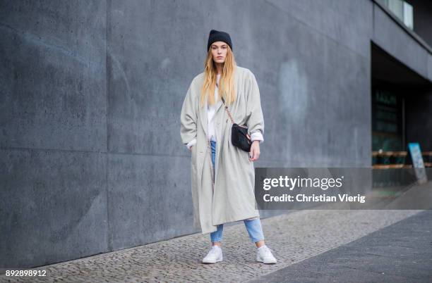 Hannah Pot d'Or wearing white Reebok sneakers, Levis denim jeans, Urban Outfitters sweater, vintage coat, black wool hat, Gucci bag on December 14,...