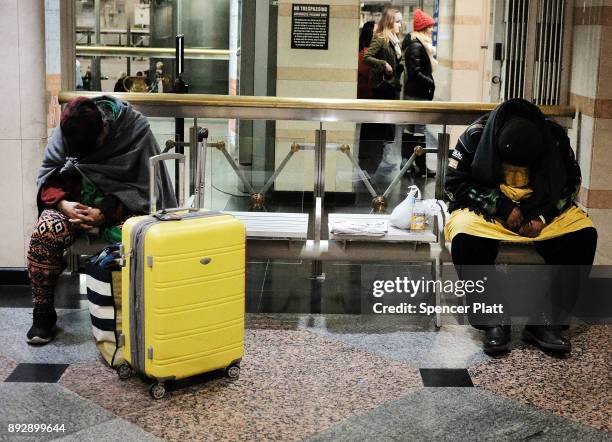 Homeless men and women sleep at a Manhattan train station on December 14, 2017 in New York City. According to a new report released by the U.S....