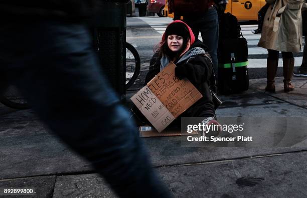 Young homeless woman panhandles on the streets of Manhattan on December 14, 2017 in New York City. According to a new report released by the U.S....