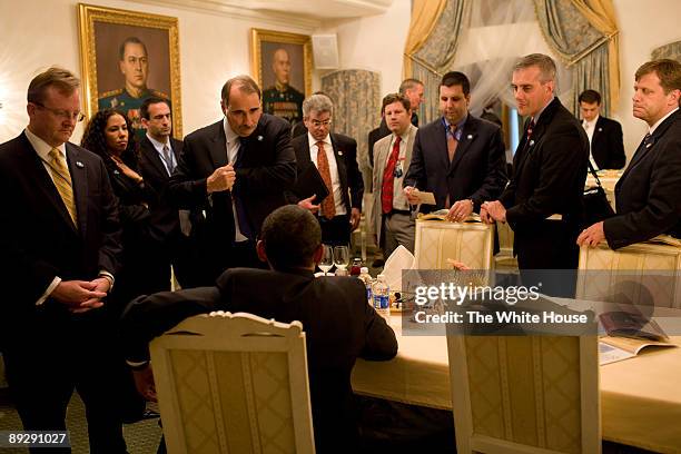 In this photo provided by The White House, during a day of meetings in Moscow, Russia, U.S. President Barack Obama is briefed by advisors : Press...