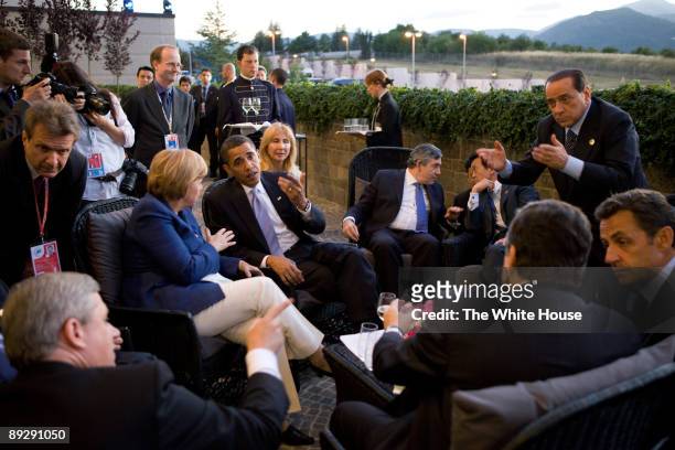 In this photo provided by The White House, U.S. President Barack Obama confers with world leaders, Canadian Prime Minister Stephen Harper, German...