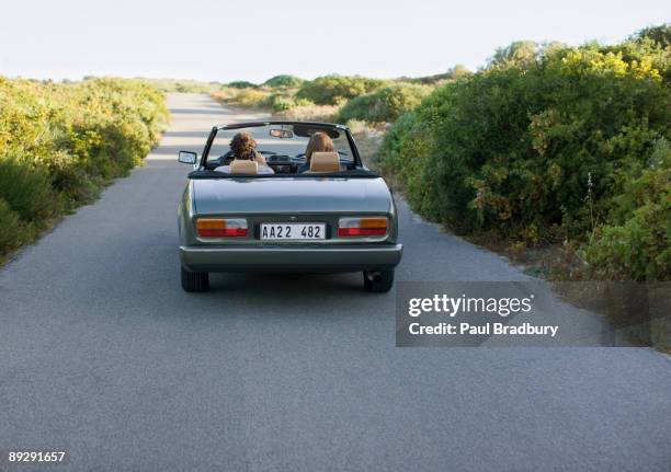 couple driving in convertible - convertible isolated stock pictures, royalty-free photos & images