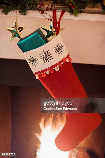 christmas stocking hanging on fireplace mantel - stockings bildbanksfoton och bilder