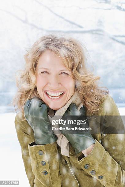 snow falling on smiling woman - 40 2009 stock pictures, royalty-free photos & images