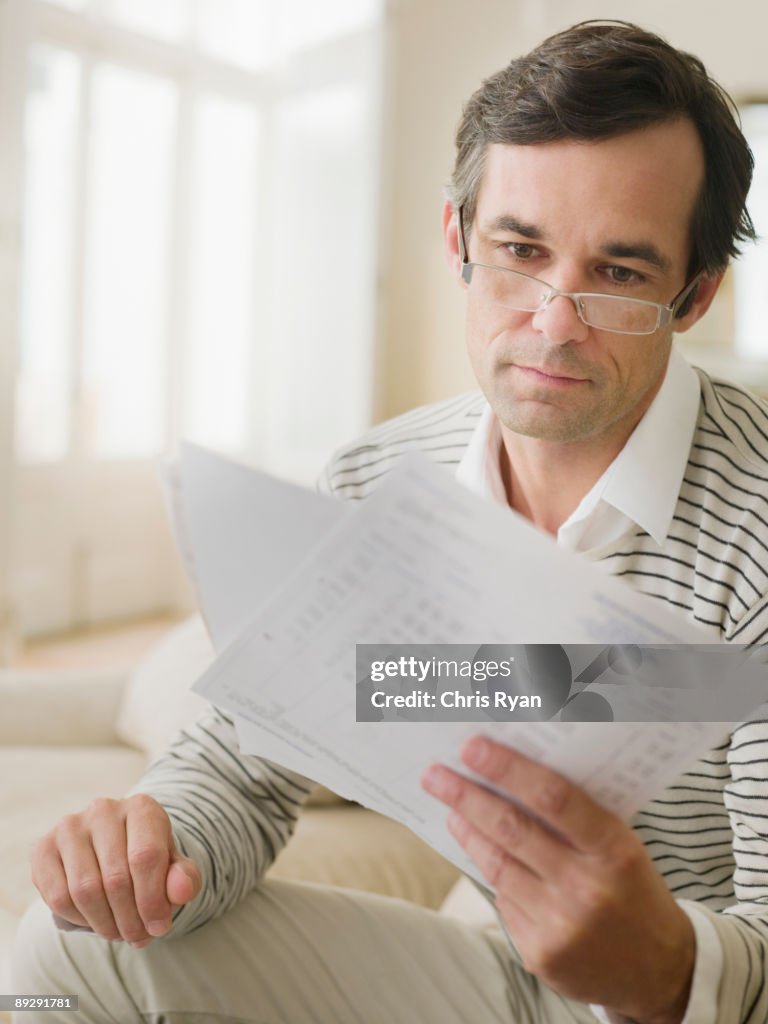 Man examining bills