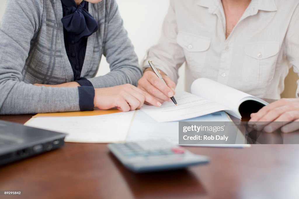 Businesswoman signing paperwork