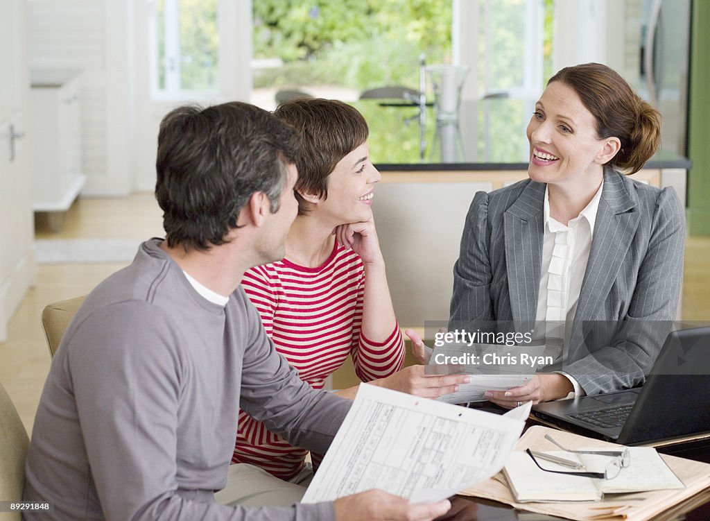 Couple meeting with financial advisor in dining room