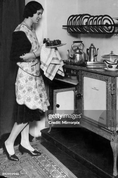 Housewife with her new Flecthers Queensday New World gas regulator oven and hob, 19th April 1930.