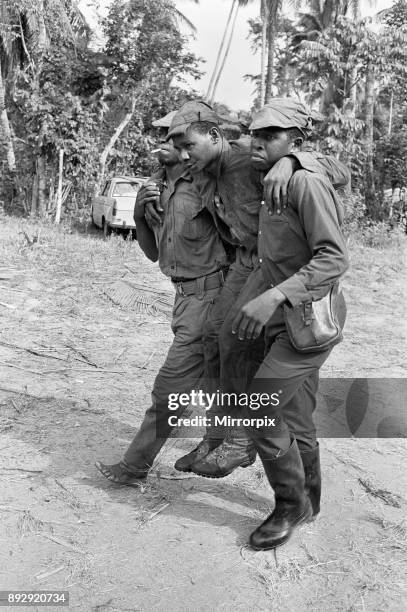 Biafran soldiers seen here carrying an injured comrade during the Biafra conflict, 11th June 1968.