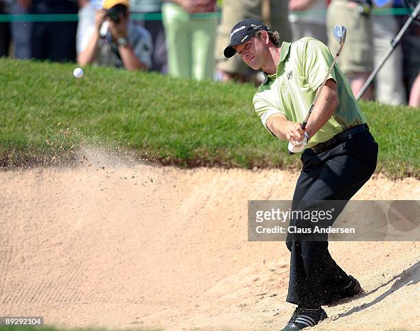 Retief Goosen hits a shot out of the bunker on the 18th hole during the Canadian Open at Glen Abbey Golf Club on July 27, 2009 in Oakville, Ontario,...