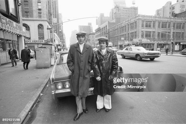 Peter Cook and Dudley Moore in their 'Pete and Dud' costumes on the corner of 7th Avenue and 45th Street, New York. They are appearing in the...