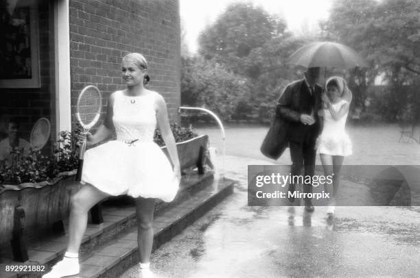 Lea Pericoli v Susanna Alexander at the rain soaked pre Wimbledon garden party at the Hurlingham Club. The girls were there braving the deluge, to...