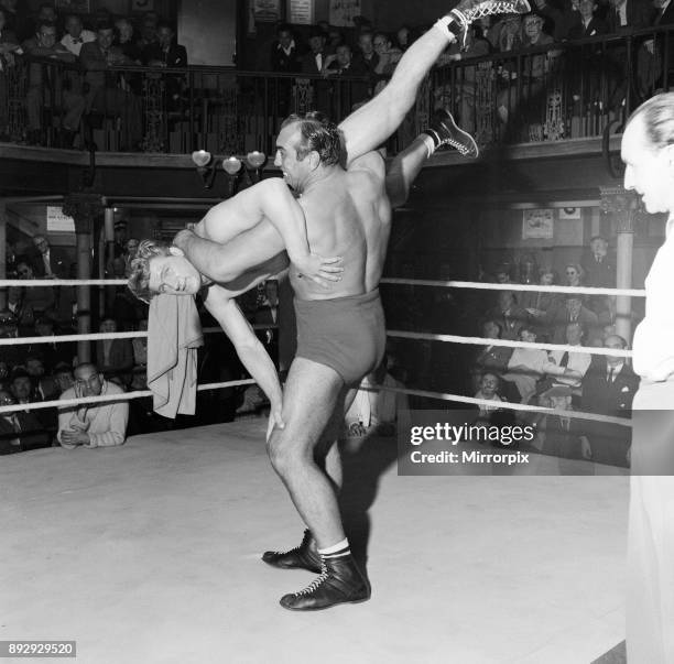 Primo Carnera, actor and professional wrestler, also a former professional boxer, pictured filming scenes for new film, A Kid for Two Farthings, at...