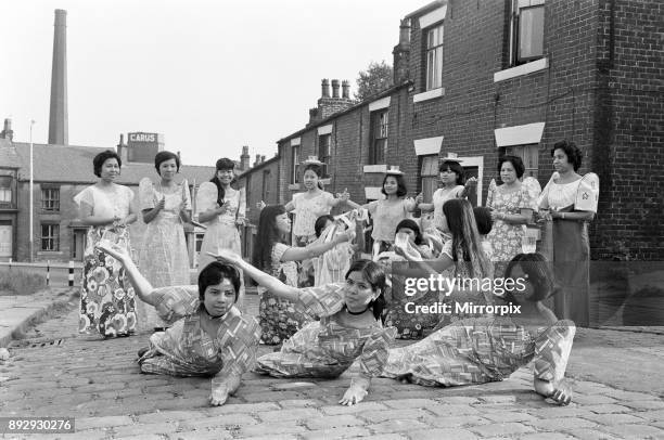 Women from Manila, who work in a Mill in Rochdale, Lancashire, give a display of national dancing in the cobbled streets of Rochdale, 20th July 1972.