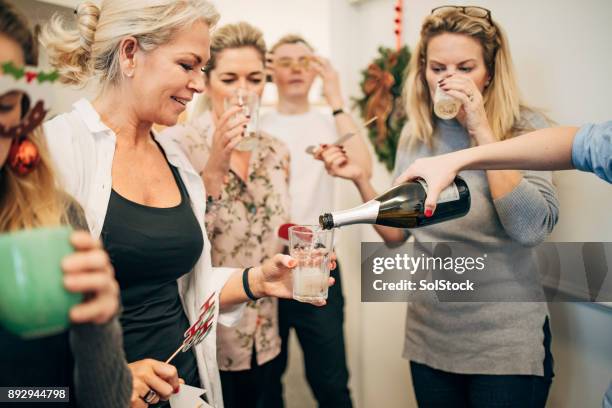 pouring champagne in the office - christmas party office stock pictures, royalty-free photos & images