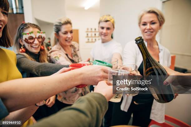 coworkers making a celebratory toast - naughty christmas ornaments stock pictures, royalty-free photos & images