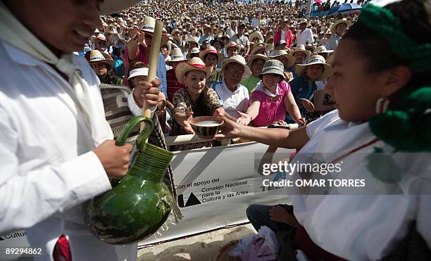 Natives from Oaxaca offer typical beverages to spectators during the Guelaguetza celebration on July 27, 2009 in Oaxaca, Mexico. The Guelaguetza...