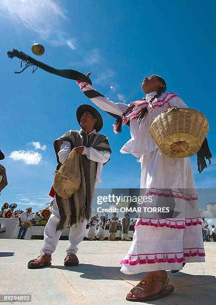 Dancers from San Pedro Ayutla throw fruits to spectators during the Guelaguetza celebration on July 27, 2009 in Oaxaca, Mexico. The Guelaguetza...