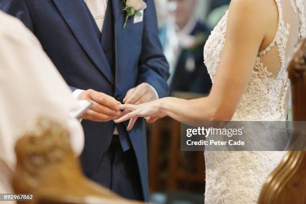 couple getting married in church - wedding ceremony ring stock pictures, royalty-free photos & images