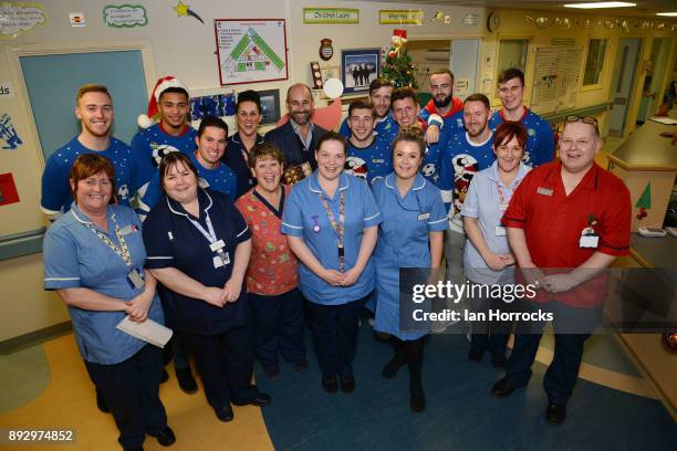 Sunderland players and chief executive Martin Bain gather around the Christmas tree with hospital staff during a Christmas visit to Durham University...