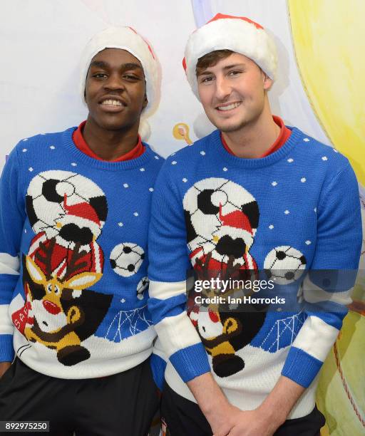Sunderland players Joel Asoro and Ethan Robson line up in their Christmas jumpers during a Christmas visit to Sunderland Royal Infirmary on December...
