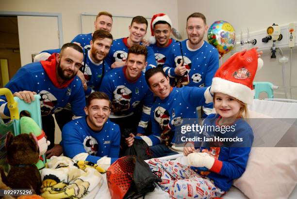 Pheobe Dodds 5 of Consett is presented with Christmas gifts by the Sunderland squad at Durham University Hospital on December 14, 2017 in Sunderland,...