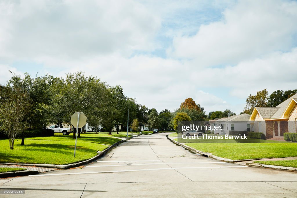 View of street in residential neighborhood on sunny afternoon