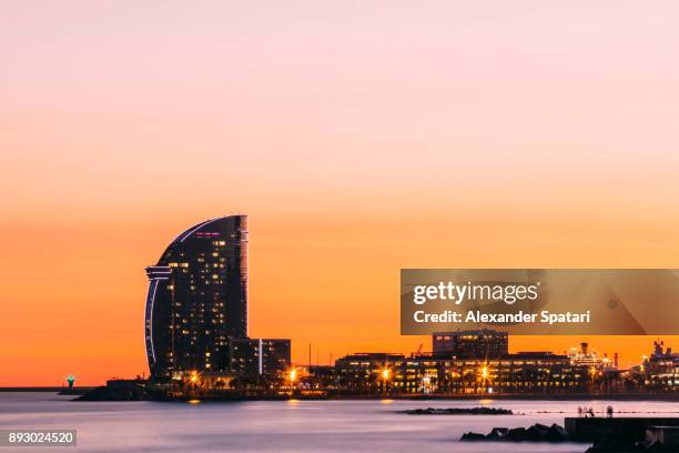 barcelona skyline during sunset, catalonia, spain - barceloneta beach stock pictures, royalty-free photos & images